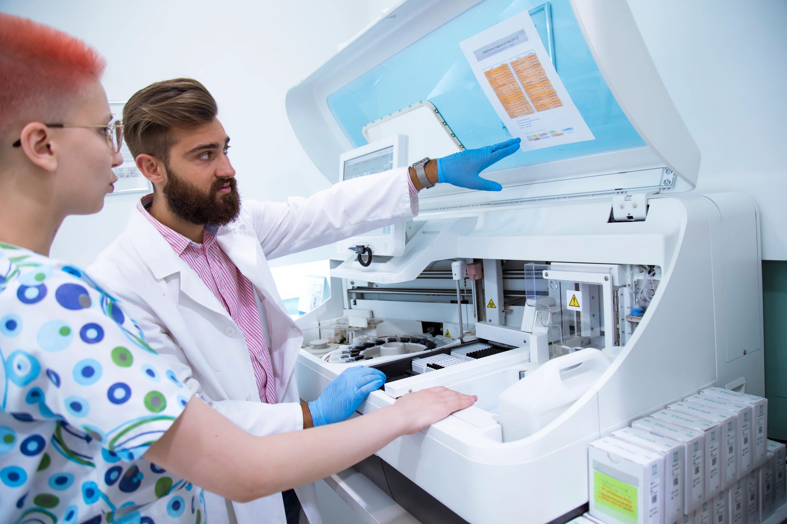 Technician preparing blood sample in hematology lab